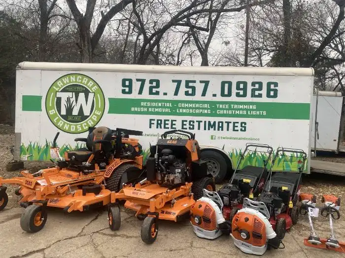 TW Lawn Care trailer with commercial mowers, blowers, and trimmers displayed
